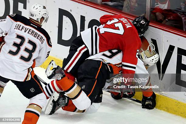 Johnny Oduya of the Chicago Blackhawks checks Matt Beleskey of the Anaheim Ducks in Game Six of the Western Conference Finals during the 2015 NHL...