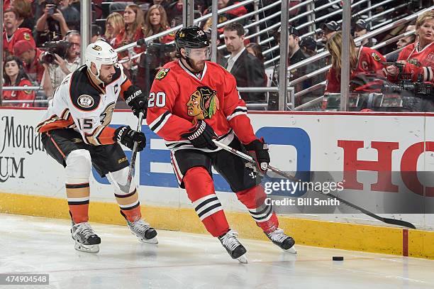 Ryan Getzlaf of the Anaheim Ducks and Brandon Saad of the Chicago Blackhawks chase the puck in Game Six of the Western Conference Finals during the...