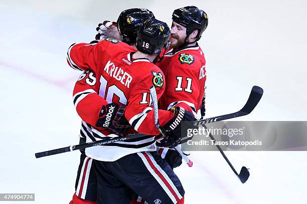 Andrew Shaw celebrates with Andrew Desjardins and Marcus Kruger of the Chicago Blackhawks against the Anaheim Ducks in Game Six of the Western...