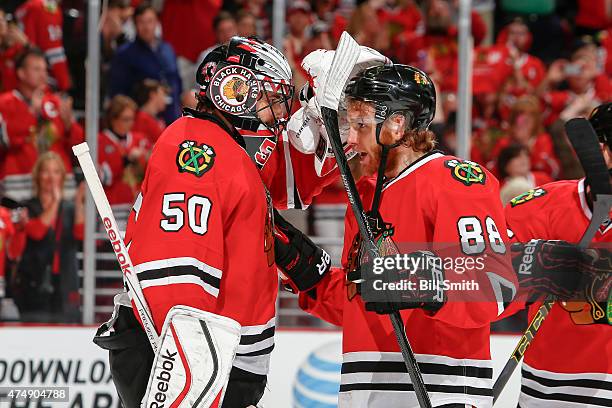 Goalie Corey Crawford and Patrick Kane of the Chicago Blackhawks celebrate after defeating the Anaheim Ducks 5-2 in Game Six of the Western...