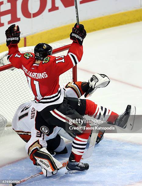 Andrew Desjardins of the Chicago Blackhawks gets tangled up with Frederik Andersen of the Anaheim Ducks in Game Six of the Western Conference Finals...