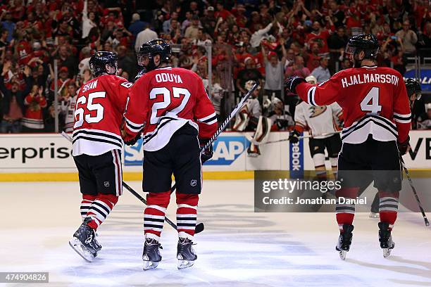 Andrew Shaw celebrates with Johnny Oduya and Niklas Hjalmarsson of the Chicago Blackhawks against the Anaheim Ducks in Game Six of the Western...