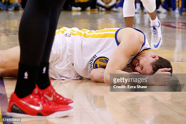 Klay Thompson of the Golden State Warriors is injured in the fourth quarter against the Houston Rockets during game five of the Western Conference...