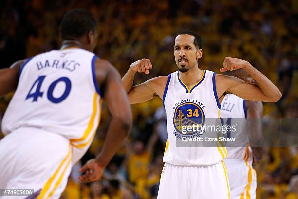 Shaun Livingston of the Golden State Warriors celebrates with teammate Harrison Barnes in the second half against the Houston Rockets during game...