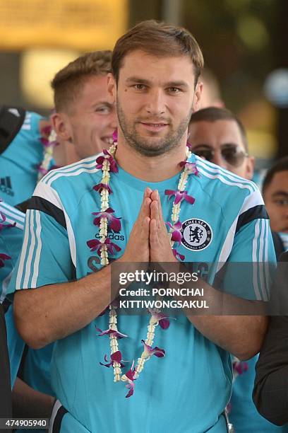 Chelsea football player Branislav Ivanovic gives a traditional Thai greeting upon the team's arrival at Don Muang Airport in Bangkok on May 28, 2015....