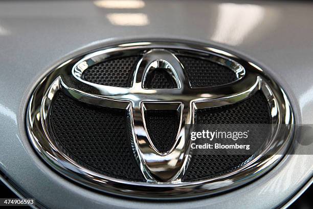 Totota Motor Corp. Badge sits above the front grill of a Toyota Corolla GLi automobile assembled at the company's Pakistan affiliate Indus Motor...
