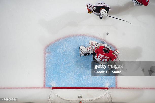 Goalie Corey Crawford of the Chicago Blackhawks gets in position to stop the puck, as Patrick Maroon of the Anaheim Ducks skates in, in Game Six of...