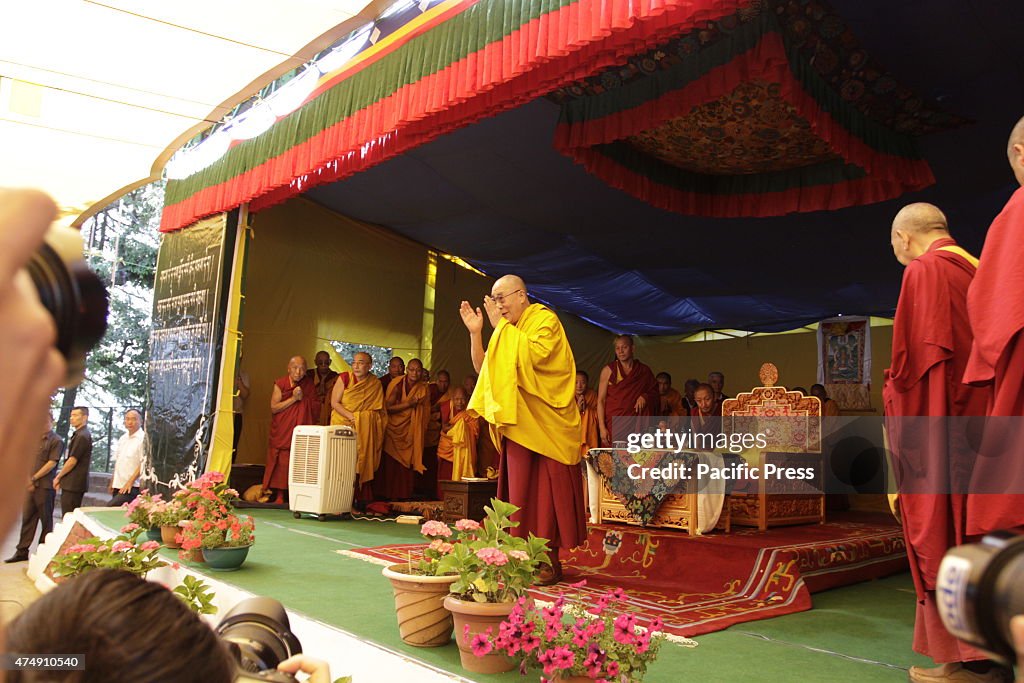 Tibetan spiritual leader the Dalai Lama praying before he...