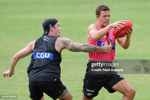 Luke Ball is tackled by Dayne Beams during a Collingwood Magpies AFL training session at the Southport Football Club on February 26, 2014 on the Gold...