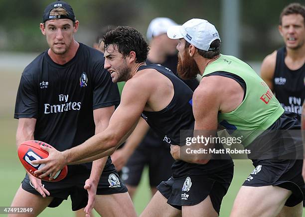 Alex Fasolo handballs in the tackle during a Collingwood Magpies AFL training session at the Southport Football Club on February 26, 2014 on the Gold...