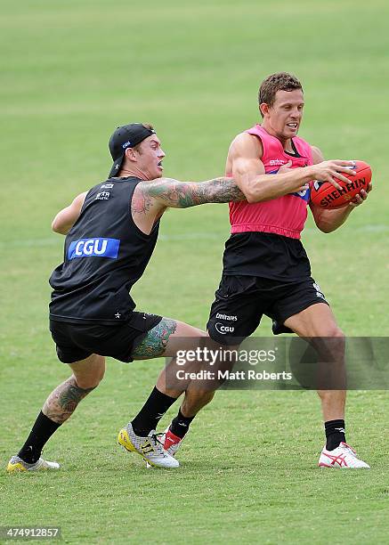 Luke Ball is tackled by Dayne Beams during a Collingwood Magpies AFL training session at the Southport Football Club on February 26, 2014 on the Gold...