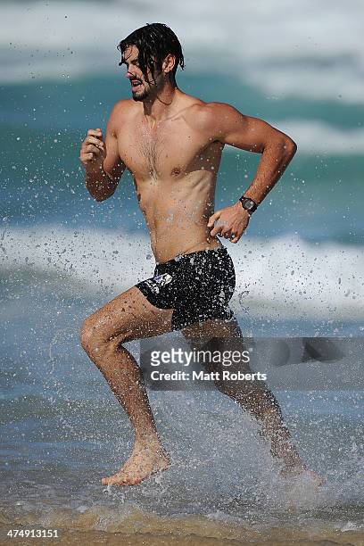 Brodie Grundy runs out of the water during a Collingwood Magpies AFL beach session at the Southport Spit on February 26, 2014 on the Gold Coast,...