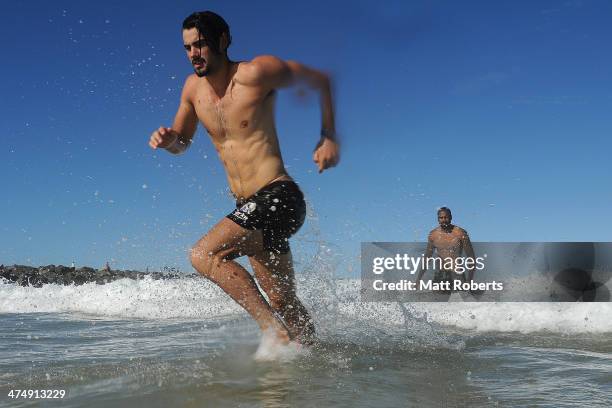 Brodie Grundy runs out of the water during a Collingwood Magpies AFL beach session at the Southport Spit on February 26, 2014 on the Gold Coast,...