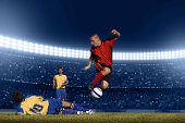 Soccer player jumping with ball