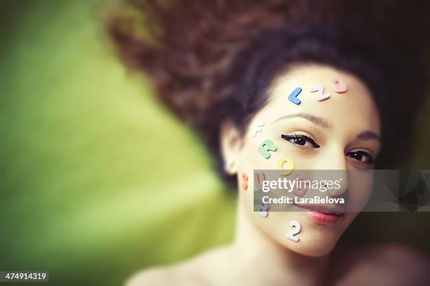 portrait of woman with letters and numbers stuck on face - glue stock pictures, royalty-free photos & images