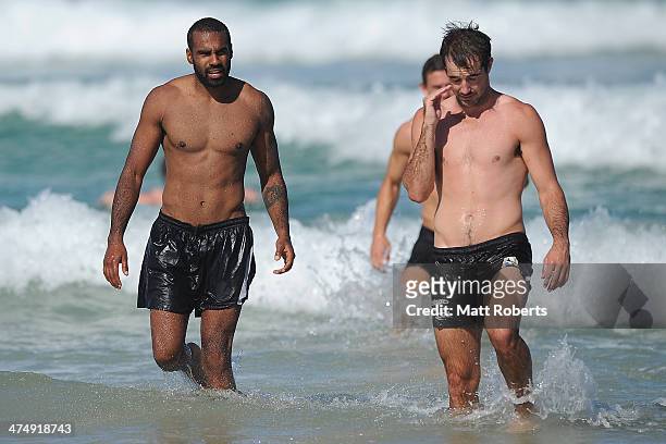 Heritier Lumumba walks out of the water during a Collingwood Magpies AFL beach session at the Southport Spit on February 26, 2014 on the Gold Coast,...