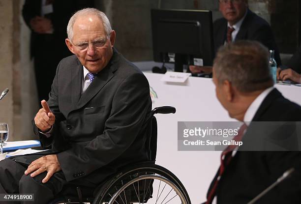 German Finance Minister Wolfgang Schaeuble chats with former U.S. Secretary of the Treasury Lawrence Summers at a symposium during a meeting of...