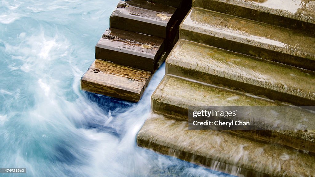 Ocean tide hitting on the stone steps