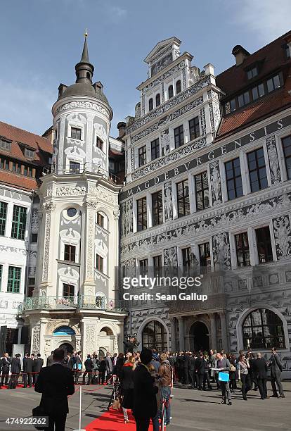 People stand outside the Residenzschloss palace, where finance ministers of the G7 group of nations were meeting inside, on May 28, 2015 in Dresden,...