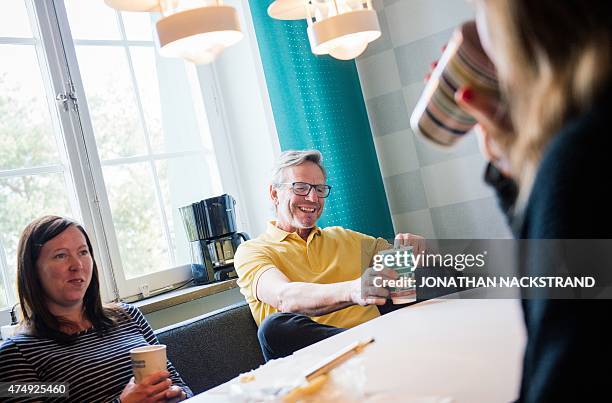 Workers at the Swedish Handball Federation meet for a traditional 'Fika', Swedish type of coffee break, on May 27, 2015 in Stockholm, Sweden. AFP...