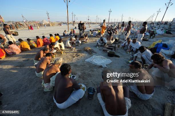 Indian devotees gather for dinner at the Sangam, the confluence of Ganges, Yamuna and mythical Saraswati rivers during Maha Kumbh Mela.