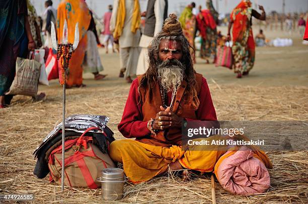 Hindu devotee prays at the Sangam, the confluence of Ganges, Yamuna and mythical Saraswati rivers during Maha Kumbh Mela.