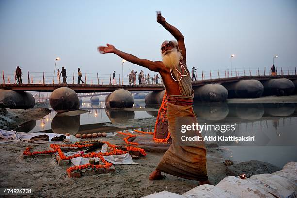 Sadhu dances to worship the Hindu gods at the Sangam, the confluence of Yamuna, Ganges and mythical Saraswati rivers during Maha Kumbh Mela.