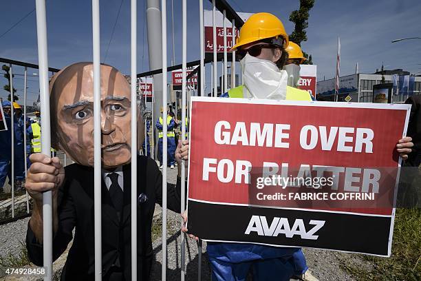 Demonstrator disguised as FIFA President Sepp Blatter takes part in a protest against the condition of workers in Qatar, on the sidelines of the 65th...