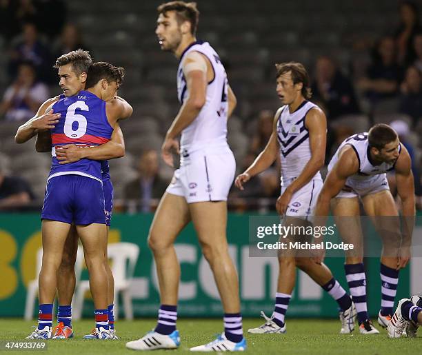 Daniel Giansiracusa and Luke Dahlhaus of the Bulldogs celebrate a goal during the round three AFL NAB Challenge match between the Western Bulldogs...