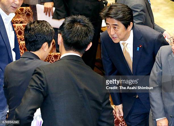 Japanese Prime Minister Shinzo Abe apologises to Democratic Party of Japan lawmaker Kiyomi Tsujimoto after a special committee to deliberate the 11...