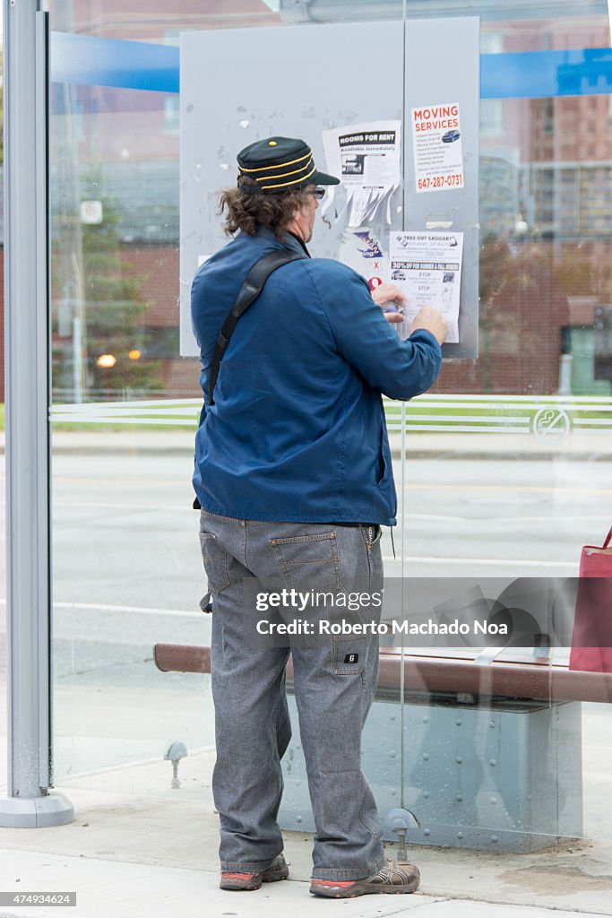 TTC public advertising murals in bus stops: a man in blue...