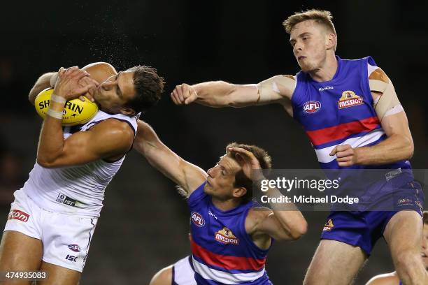 Matthew Pavlich of the Dockers marks the ball against Jordan Roughead and Dale Morris of the Bulldogs marks the ball during the round three AFL NAB...