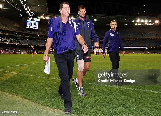 Scott Gumbleton of the Dockers walks off injured with coach Ross Lyon after their win in the round three AFL NAB Challenge match between the Western...