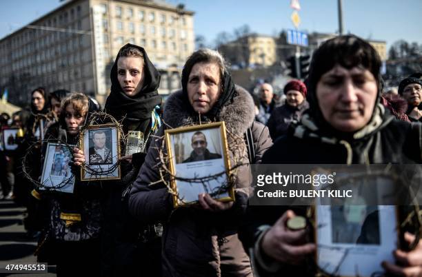 Women hold pictures of protesters who were killed in clashes with police during recent demonstrations as they take part in a commemerative procession...