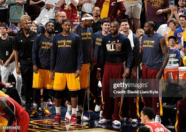 Kyrie Irving, Tristan Thompson, Brendan Haywood, Joe Harris, LeBron James, Mike Miller, and Kendrick Perkins of the Cleveland Cavaliers stand on the...