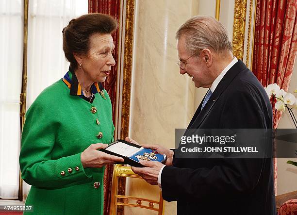 Britain's Princess Anne presents former International Olympic Committee President Jacques Rogge with his insignia of KCMG , during a private...