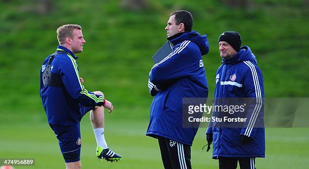 Sunderland manager Gus Poyet chats with Lee Cattermole during Sunderland training ahead of sunday's Capital One Cup Final against Manchester City, at...