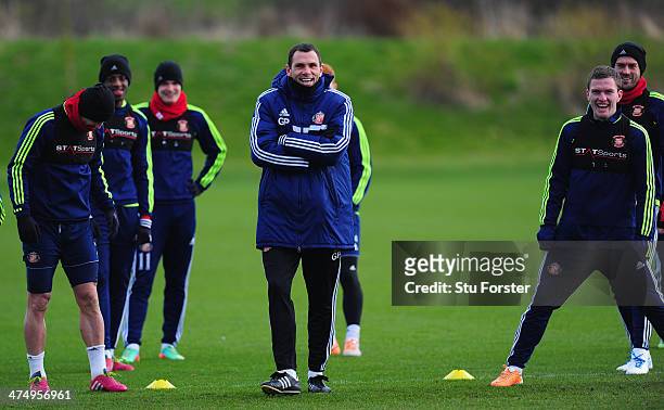 Sunderland manager Gus Poyet shares a joke with his players during Sunderland training ahead of sunday's Capital One Cup Final against Manchester...