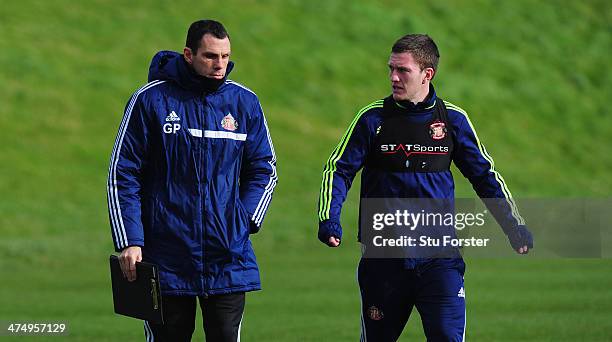 Sunderland manager Gus Poyet chats with Craig Gardner during Sunderland training ahead of sunday's Capital One Cup Final against Manchester City at...