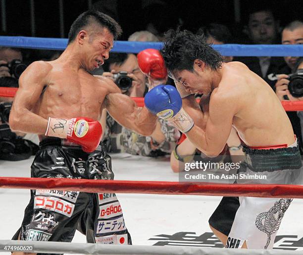 Champion Takashi Uchiyama of Japan hits his left uppercut on challenger Takashi Miura during their WBA Super Featherweight title bout at Ariake...