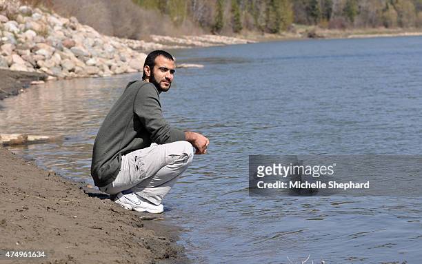 Omar Khadr stops to look out on the North Saskatchewan river during his first long walk and bike ride on May 9 two days after being freed after...