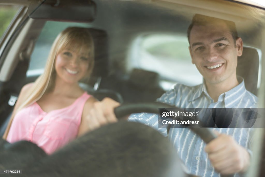 Couple driving a car and going on a road trip
