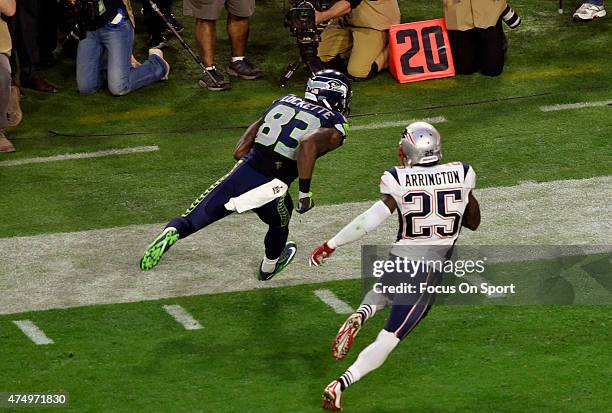 Ricardo Lockette of the Seattle Seahawks runs with the ball after catch pursued by Kyle Arrington of the New England Patriots during Super Bowl XLIX...