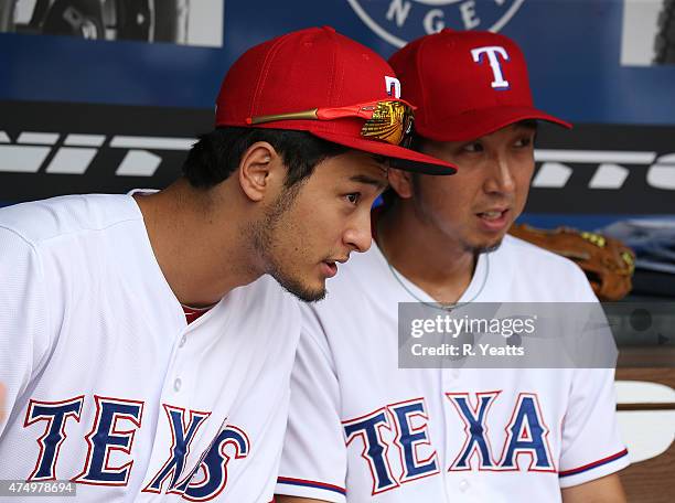 Yu Darvish of the Texas Rangers talks with Kyuji Fujikawa after Fujikawa pitches in the eighth inning against the Kansas City Royals at Globe Life...