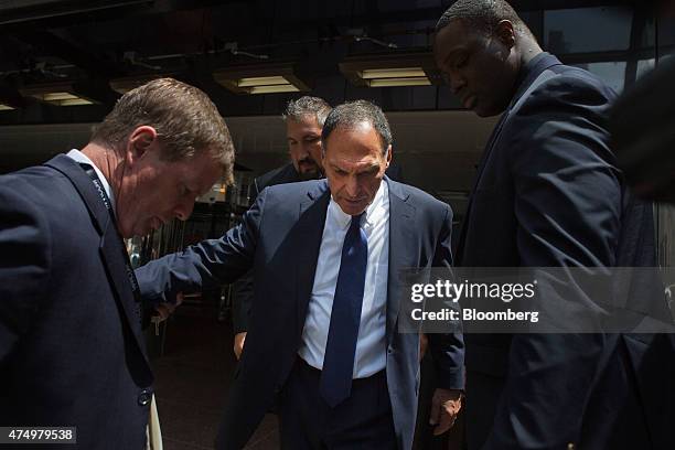 Richard "Dick" Fuld, former chief executive officer of Lehman Brothers Holdings Inc., center, exits the Grand Hyatt Hotel after speaking at the...