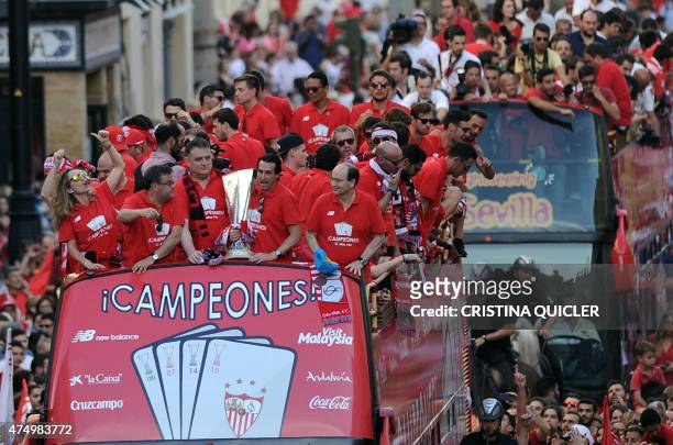 Sevilla Football Club team parade on top of a bus by a street of Sevilla to celebrate their victory in the UEFA Europa League final football match...