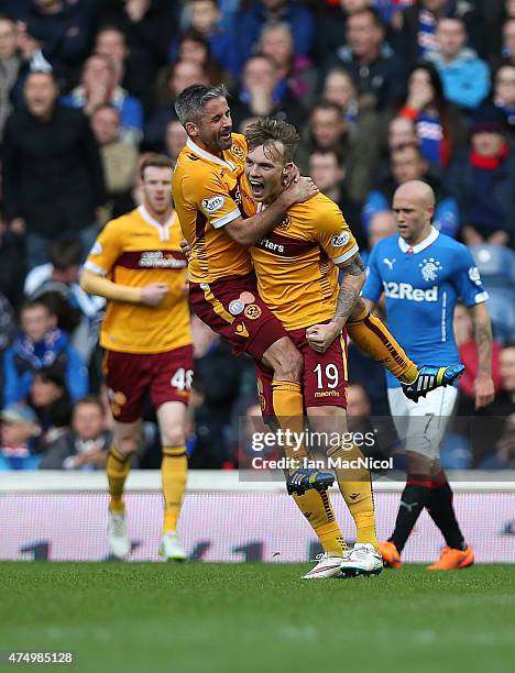 Josh Law of Motherwell is congratulated on his goal by Keith Lasley during the Scottish Premiership play off final, first leg match between Rangers...