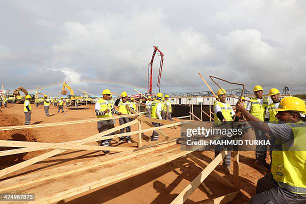 Labourers work at the site of the stadium to host the 2017 Africa Cup of Nations on February 26, 2014 in Libya's capital, Tripoli. Austrian firm PORR...