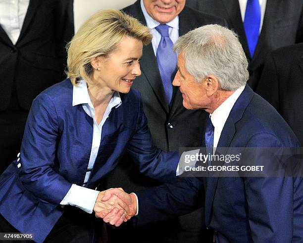 German minister of Defence Ursula Von der Leyen shakes hands with US secretary of Defence Chuck Hagel during the NATO family picture following the...