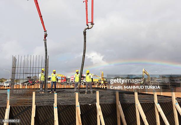 Labourers work at the site of the stadium to host the 2017 Africa Cup of Nations on February 26, 2014 in Libya's capital, Tripoli. Austrian firm PORR...